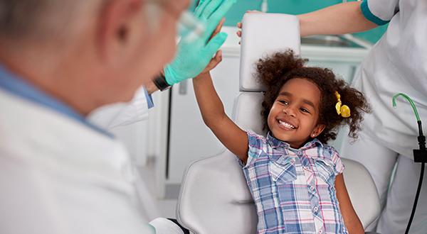 little girl highfiving dentist